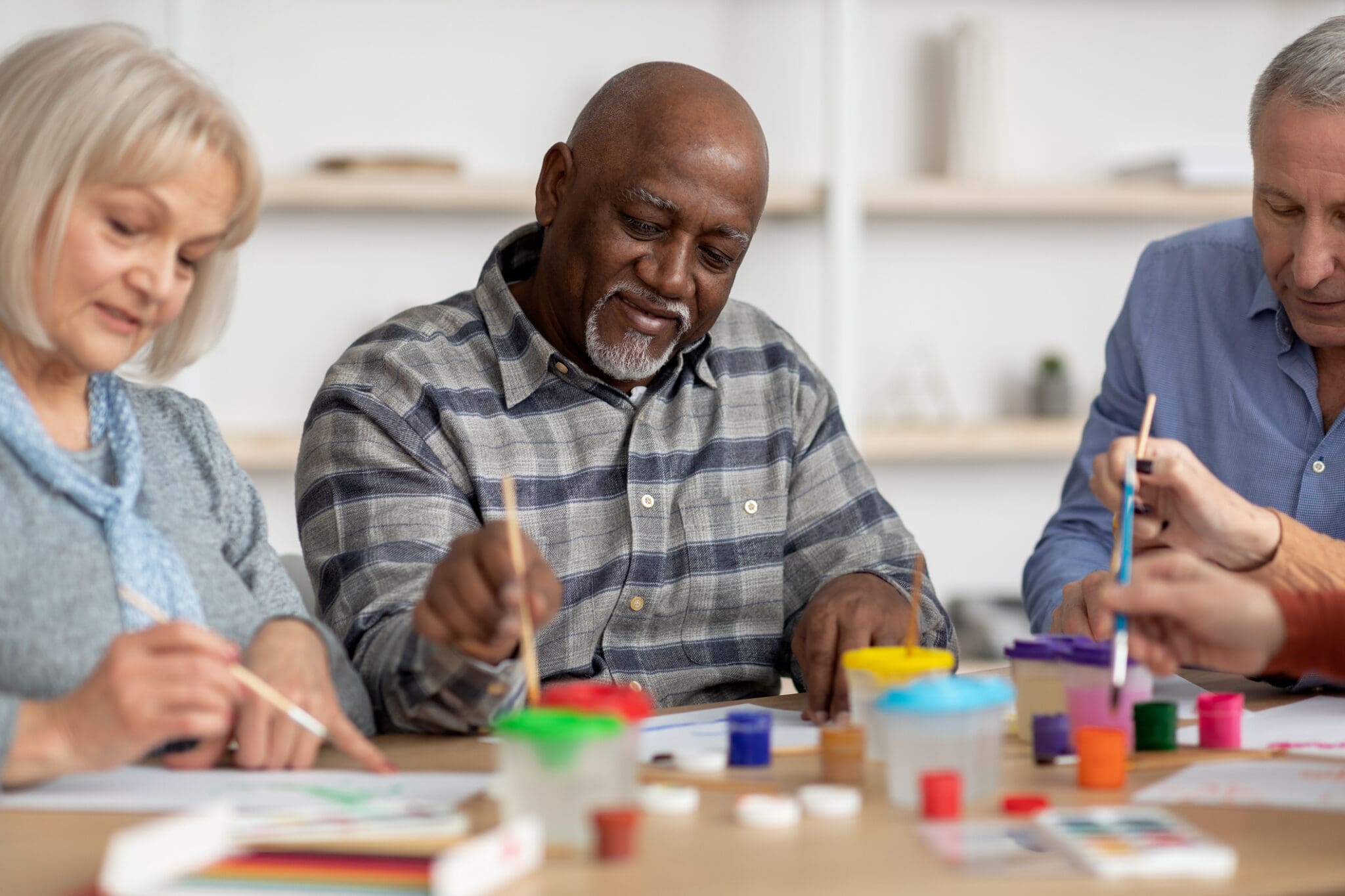Senior residents enjoying an art class, sharing a creative and engaging activity at a retirement home.