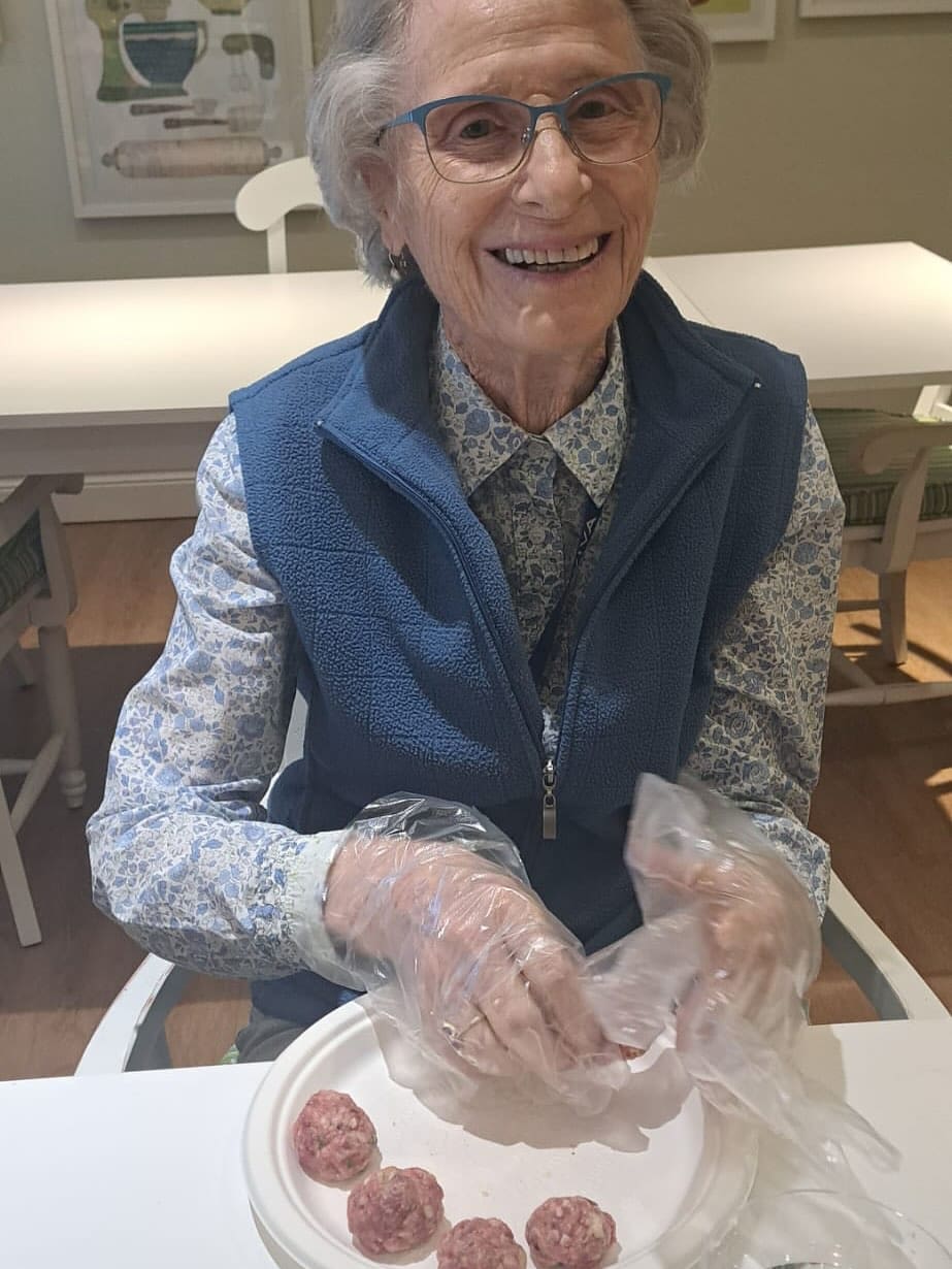 An elderly woman smiles.